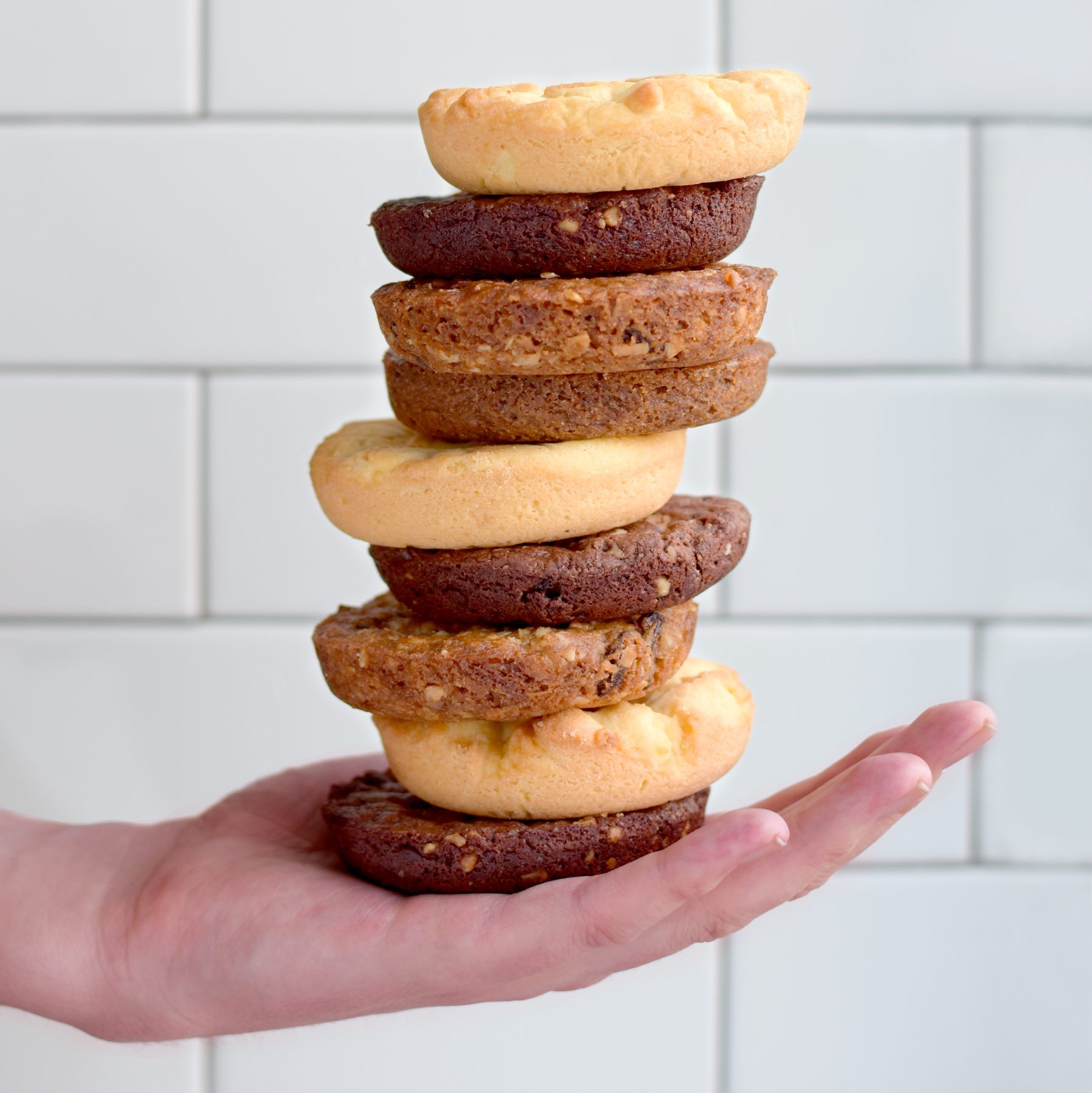 Stan's Donuts — Cookie tower held against subway tile
